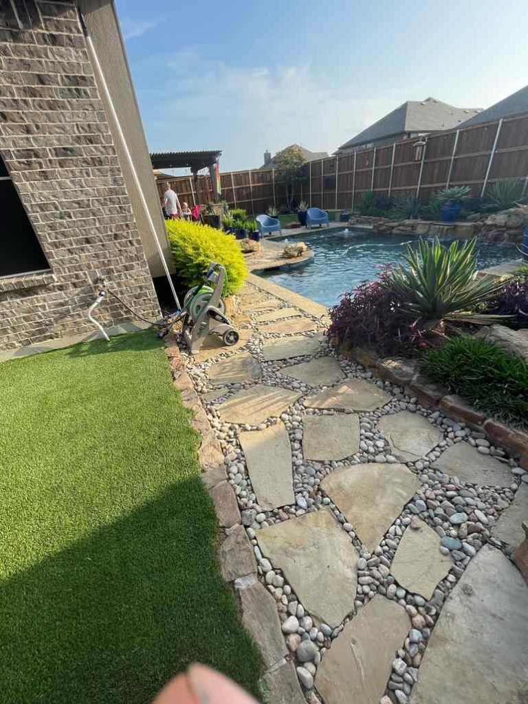 Poolside turf with rockscape by Allegiance Turf